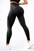 Black leggings worn by a person on a white background