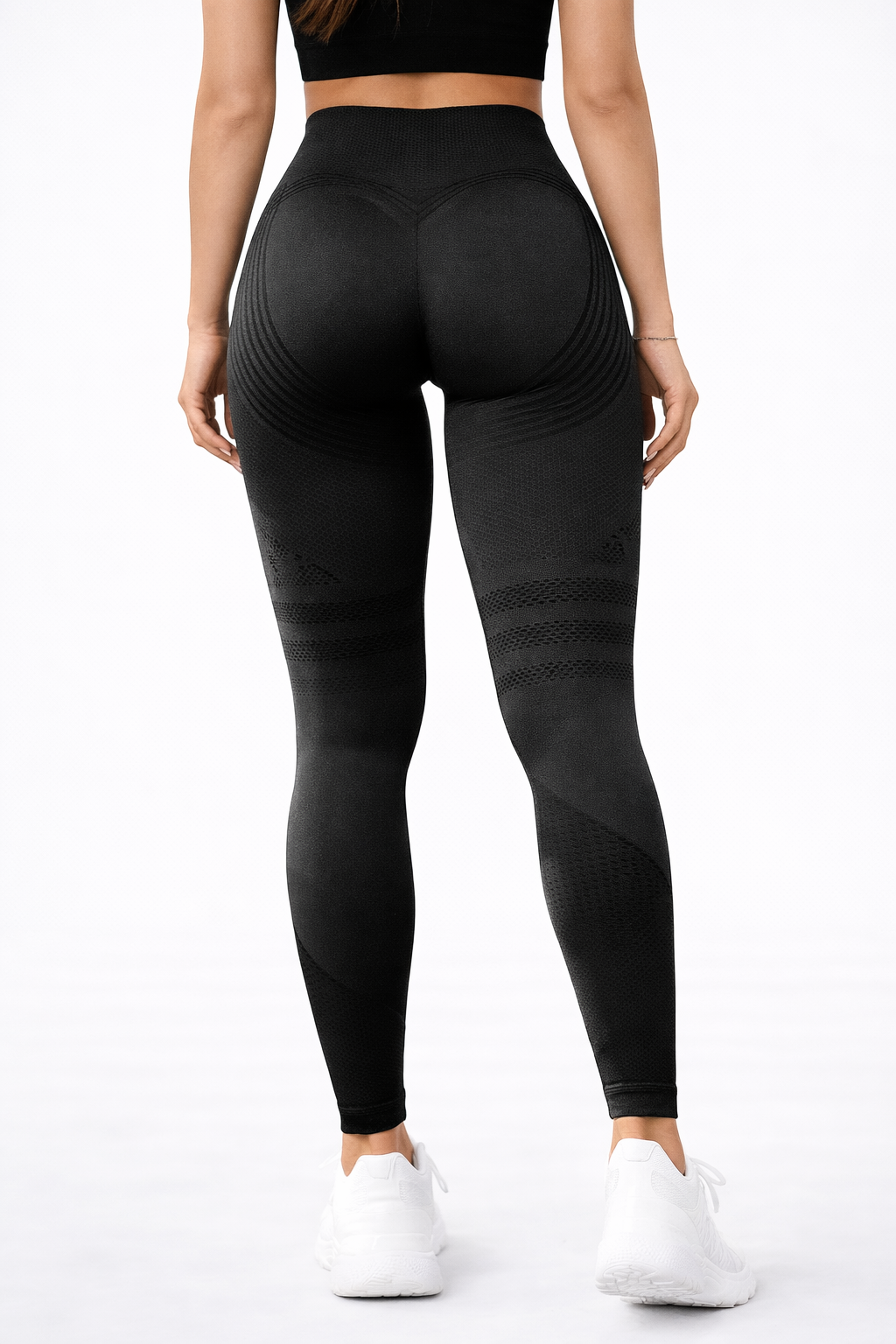 Person wearing black leggings on a white background