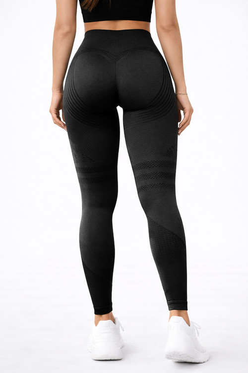 Person wearing black leggings on a white background