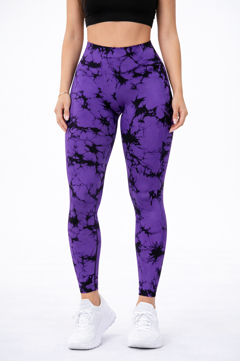Purple leggings with black patterns worn by a person on a white background