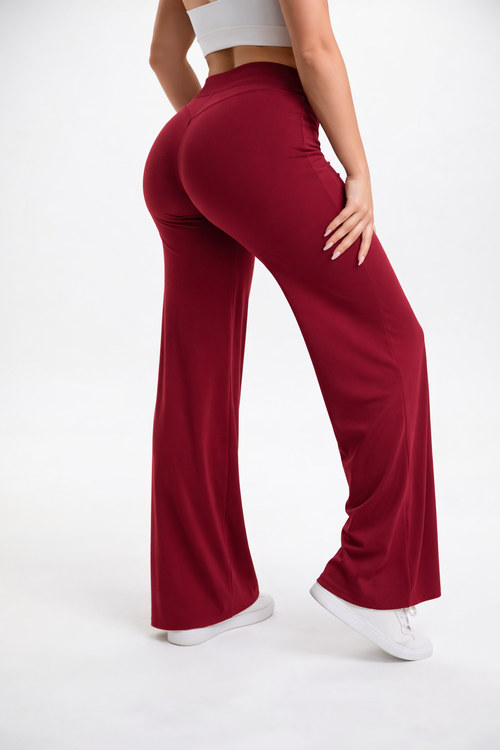 Red flared pants worn by a person on a white background