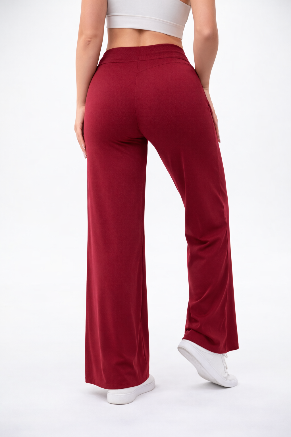 Red pants worn by a person on a white background